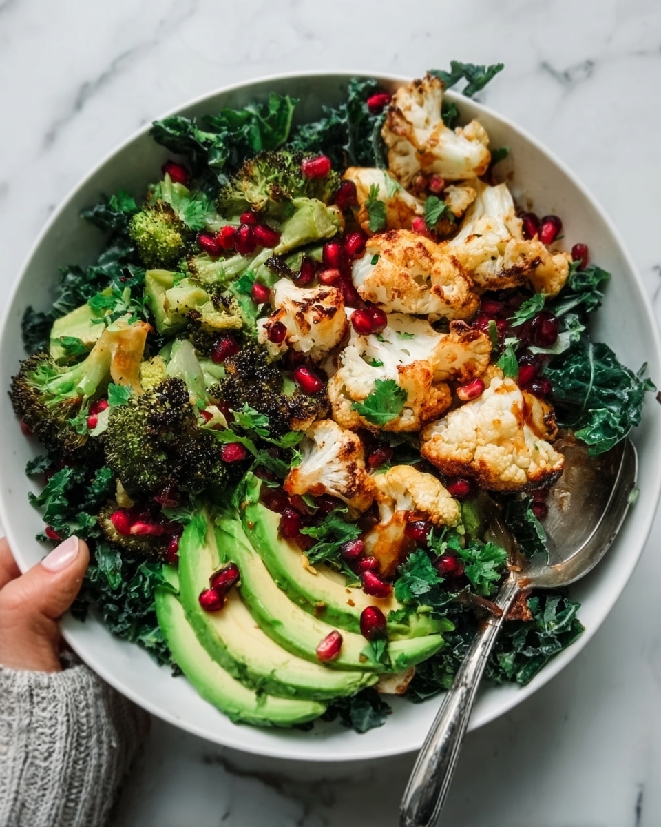 A white bowl filled with a colorful salad placed on a white marbled surface, featuring three main layers. The bottom layer has dark green curly kale leaves. On top of it, there are roasted cauliflower florets with a light golden brown color mixed with roasted broccoli pieces that have slightly charred edges. The dish is also decorated with bright green sliced avocado and scattered deep red pomegranate seeds. A silver spoon rests inside the bowl with a woman's hand holding it. The lighting is bright and natural, highlighting the textures and colors of the fresh ingredients. Photo taken with an iphone --ar 4:5 --v 7