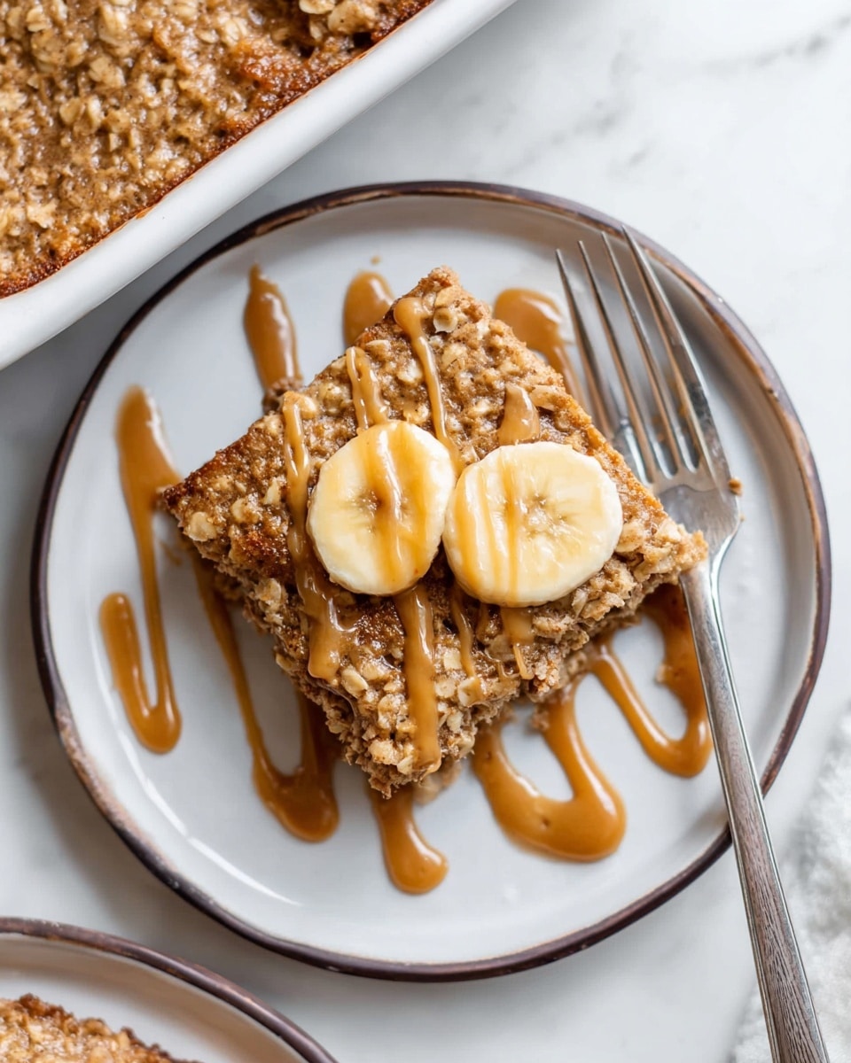 A baked square oat bar dessert in a white rectangular dish, divided into six equal pieces. The top layer is golden brown with a rough texture from the oats mixed throughout. There is a smooth, light brown sauce drizzled in a zigzag pattern all over the bars, creating a shiny contrast against the matte oat surface. The edges of the dish show a slightly darker baked crust, and the dish sits on a white marbled textured surface. photo taken with an iphone --ar 4:5 --v 7