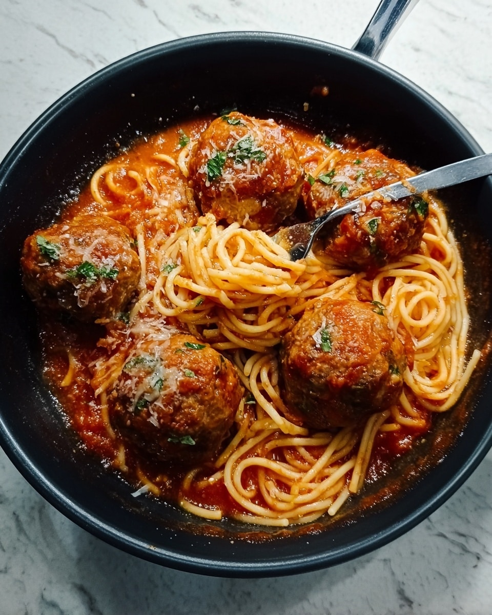 A black pot filled with a dish of long, pale yellow spaghetti noodles mixed and partially submerged in a thick, rich red tomato sauce with some chunks of tomatoes and green herbs visible. On top of the spaghetti and sauce, there are five large, round meatballs coated in the same tomato sauce. The meatballs show a textured surface with bits of onions and herbs mixed in, giving them a slightly uneven, rustic look. The pot is placed on a white marbled texture. photo taken with an iphone --ar 4:5 --v 7