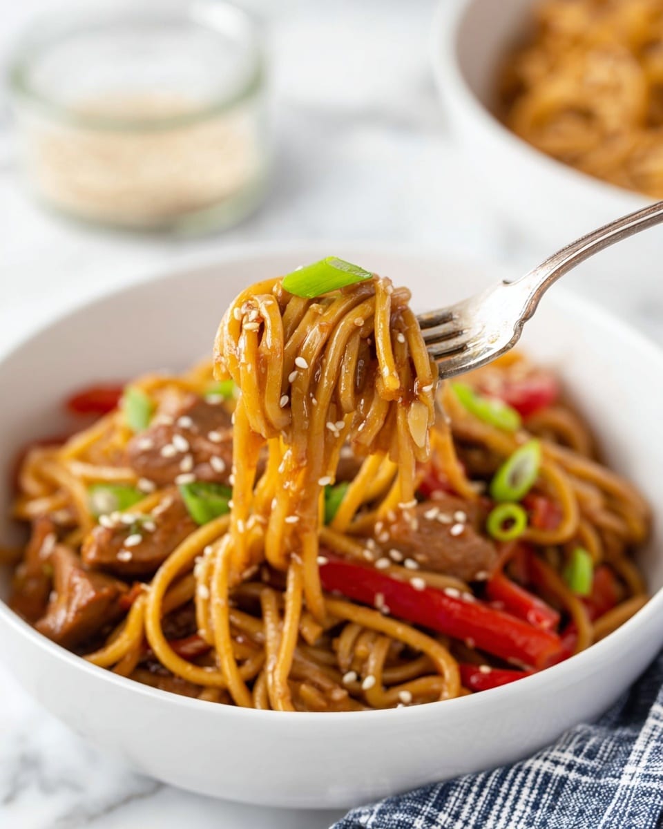 The image shows a white slow cooker filled with cooked yellow noodles mixed with chunks of light brown chicken and bright red bell pepper strips. Small pieces of green onions are scattered throughout the noodles, and a sprinkling of white sesame seeds is visible on top. A pair of silver tongs is lifting a tangle of noodles from the cooker, showing the texture and glossiness of the dish. The inside of the cooker has some sauce stains around the edges, adding to the freshly cooked look. The whole scene is set on a white marbled surface. photo taken with an iphone --ar 4:5 --v 7