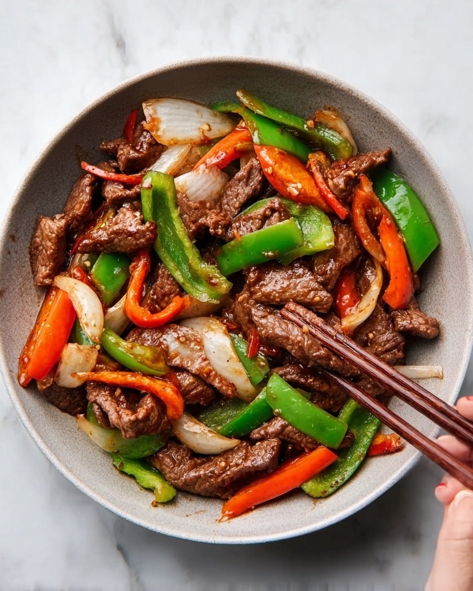 A dish served in a white bowl filled with stir-fried beef pieces mixed with bright green bell peppers, orange carrot slices, and white onions. The beef looks soft and brown with a slightly glossy sauce coating it. The bell peppers and carrots are cut into medium-sized chunks, and the onions are in large slices, adding a fresh look and texture contrast. A woman's hand holds wooden chopsticks picking up some beef and vegetables from the bowl. The bowl rests on a white marbled surface, adding a clean and elegant feel to the image. Photo taken with an iphone --ar 4:5 --v 7