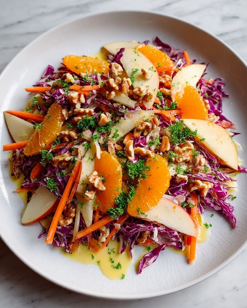 A colorful salad on a white plate shows several layers starting with shredded purple cabbage creating a textured base. Over this, there are thin orange carrot sticks and pale slices of apple spread across. Bright orange segments add juicy bursts of color, while whole walnut pieces add a rough texture on top. Small green parsley leaves are sprinkled throughout, giving fresh green spots. The salad is lightly drizzled with a creamy yellow dressing that covers parts of the ingredients, blending everything visually. The plate is on a white marbled surface. photo taken with an iphone --ar 4:5 --v 7