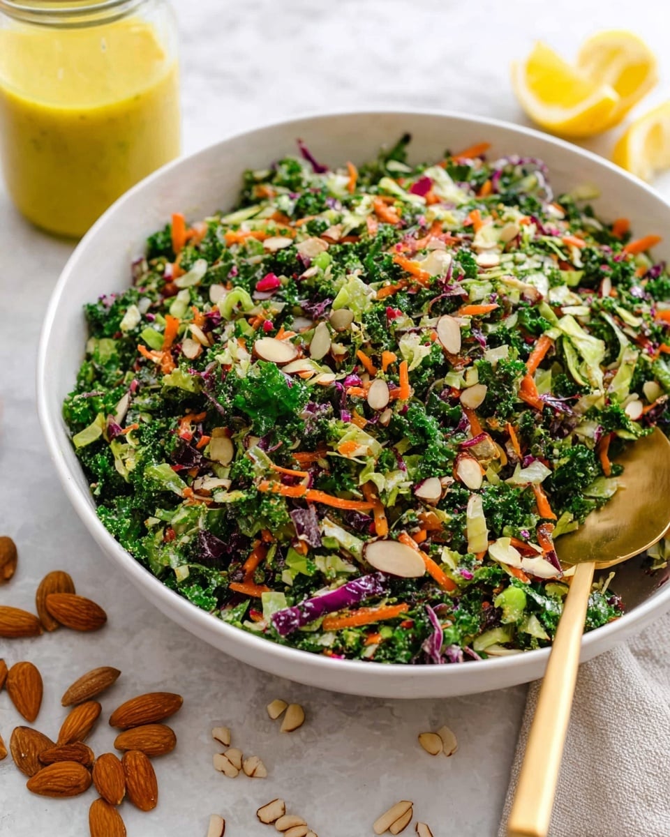 A close-up image shows a white bowl filled with a colorful chopped salad made of green kale, small pieces of broccoli, orange carrot shreds, purple cabbage, and sunflower seeds, all mixed together. A woman's hand is pouring a creamy, golden-yellow dressing from a clear glass jar onto the salad. A gold spoon lies inside the bowl on the right side, resting on the salad. The background and surface have a white marbled texture, creating a clean and bright scene. photo taken with an iphone --ar 4:5 --v 7